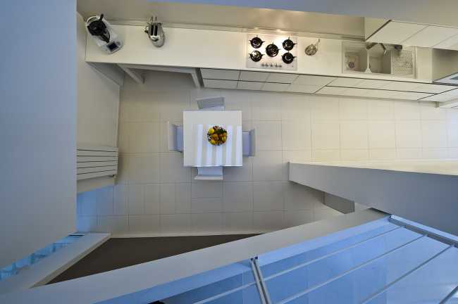 double volume white minimalist kitchen