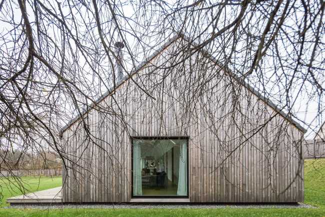 Family house in Pavilnys, open wooden space immersed in nature.