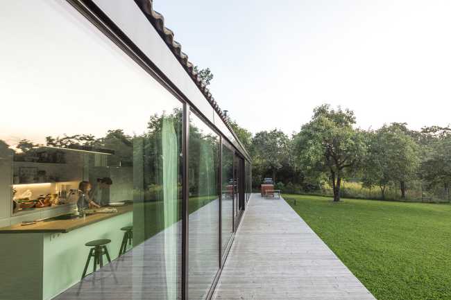 Family house in Pavilnys, open wooden space immersed in nature.