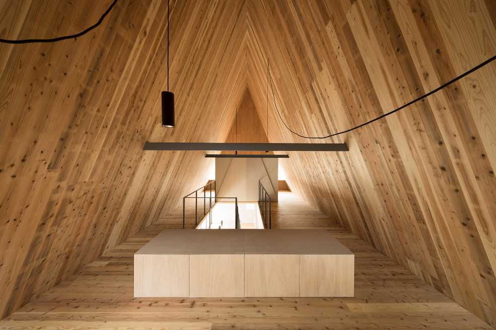Rich wooden texture and triangular prism shape for a family home.
