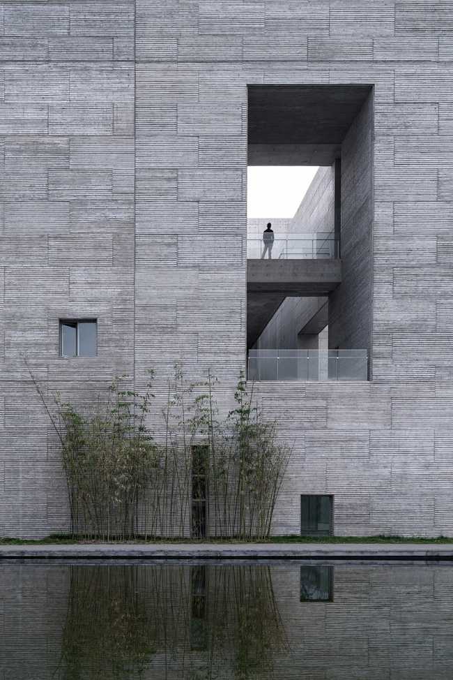 cultural center structure cement double volume parapet glass lake