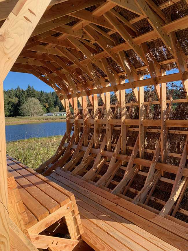 Circular interior wooden pavilion with internal seat