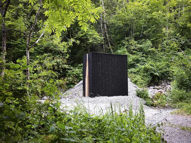 Meditative chapel in the wood in charred wood