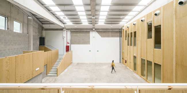 Multifunctional center with wood-clad interior