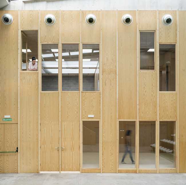 Multifunctional center with wood-clad interior