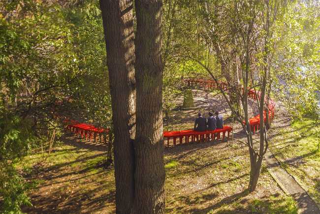 Circular bench continuous red between the trees