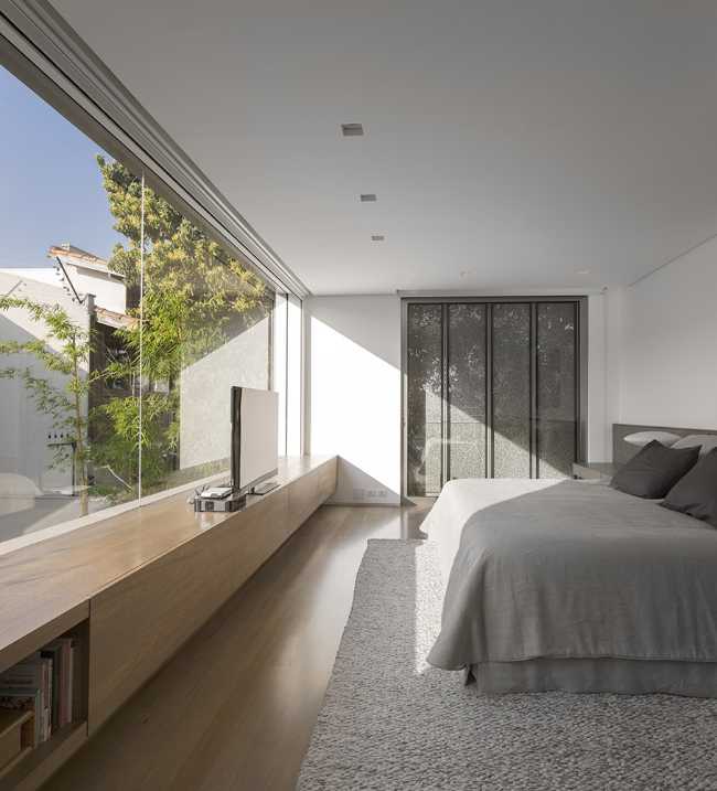 master bedroom with large window on the courtyard