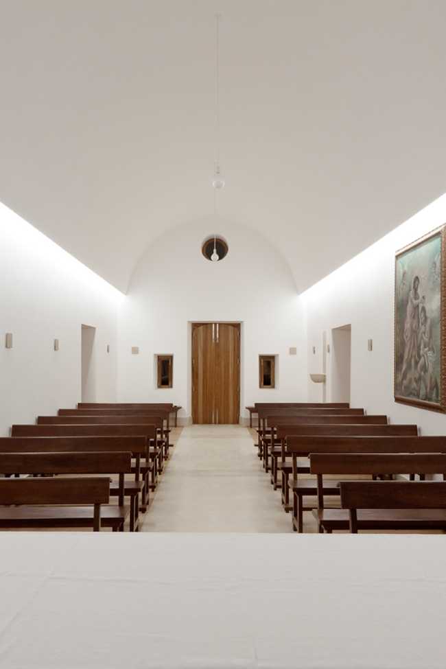 White chapel interior with wooden benches
