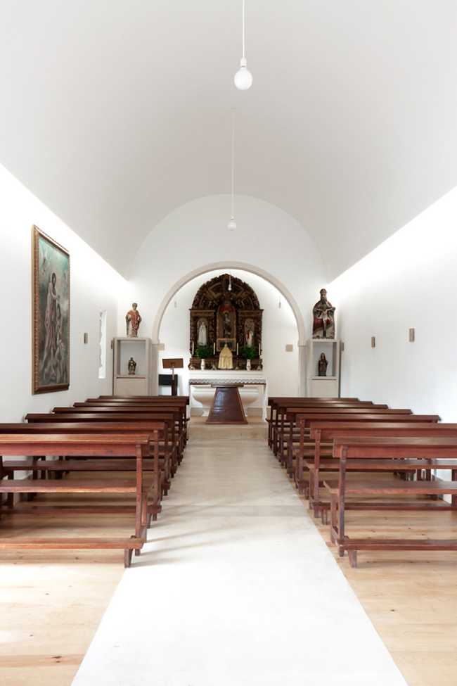 White chapel interior with wooden benches