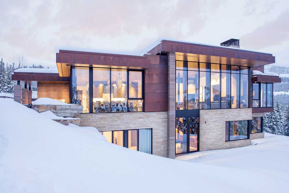 Villa with concrete structure and corten facing windows