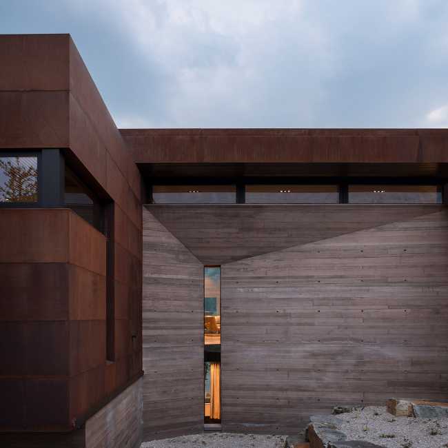 Villa with concrete structure and corten cladding