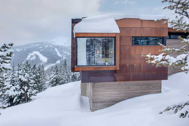 Villa with concrete structure and corten coating snow winter