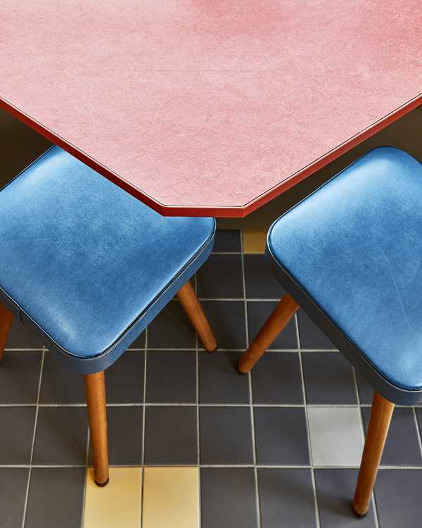 Pink coffee table and blue chairs