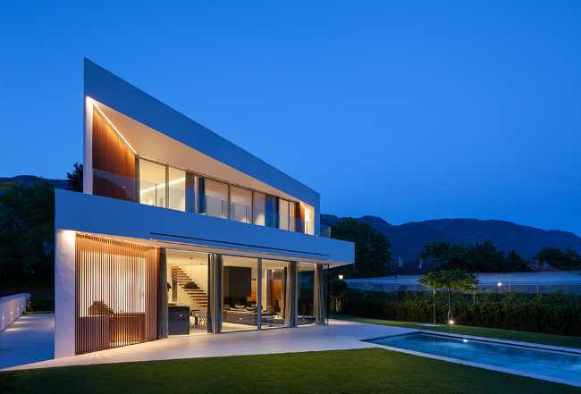 Modern villa with illuminated swimming pool