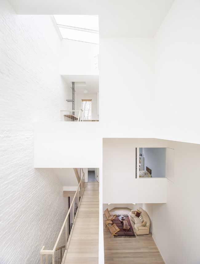 Interior renovation in Brooklyn. Triple-height space at the center of living spaces