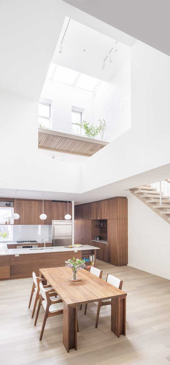 Interior renovation in Brooklyn. Triple-height space at the center of living spaces