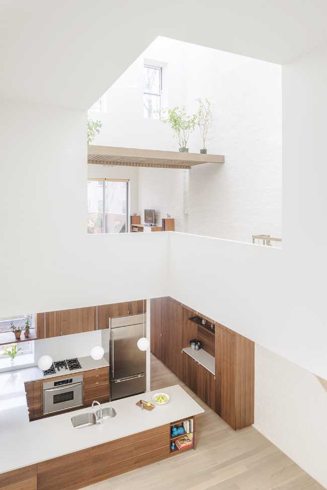 Interior renovation in Brooklyn. Triple-height space at the center of living spaces