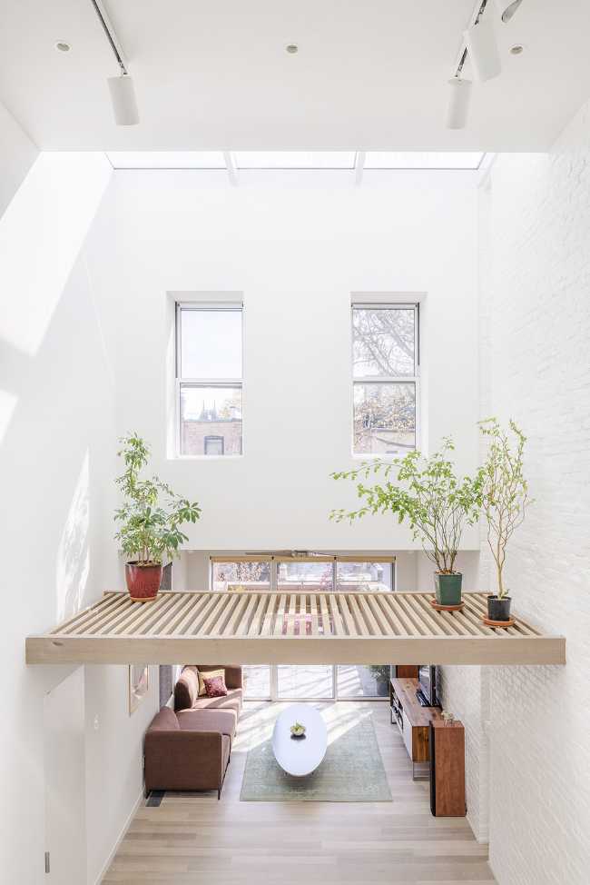 Interior renovation in Brooklyn. Triple-height space at the center of living spaces