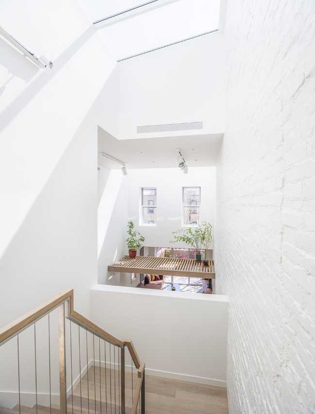 Interior renovation in Brooklyn. Triple-height space at the center of living spaces