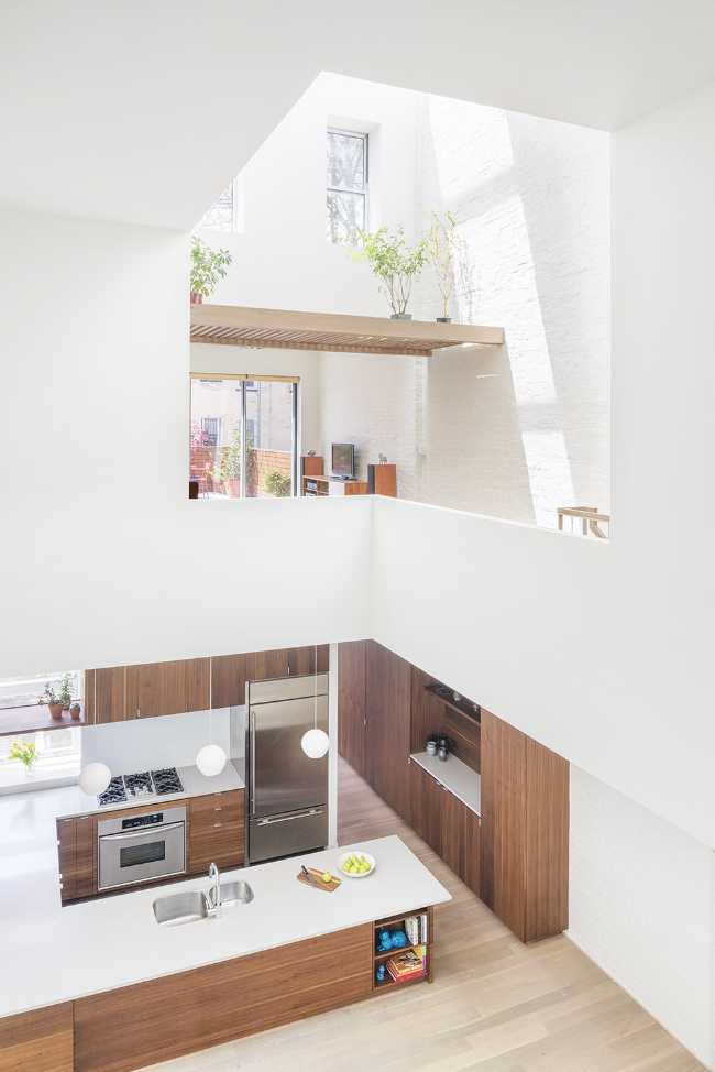 Interior renovation in Brooklyn. Triple-height space at the center of living spaces