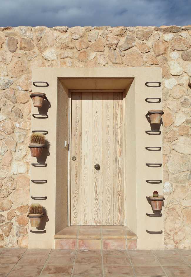 Mediterranean house situated between ploughed fields and stones. Ecological habitat in Spain