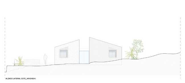 Mediterranean house situated between ploughed fields and stones. Ecological habitat in Spain