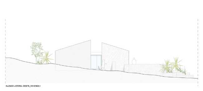 Mediterranean house situated between ploughed fields and stones. Ecological habitat in Spain