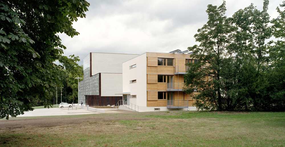 One cube, four facades. Warm, soft wood complements the white plaster façade