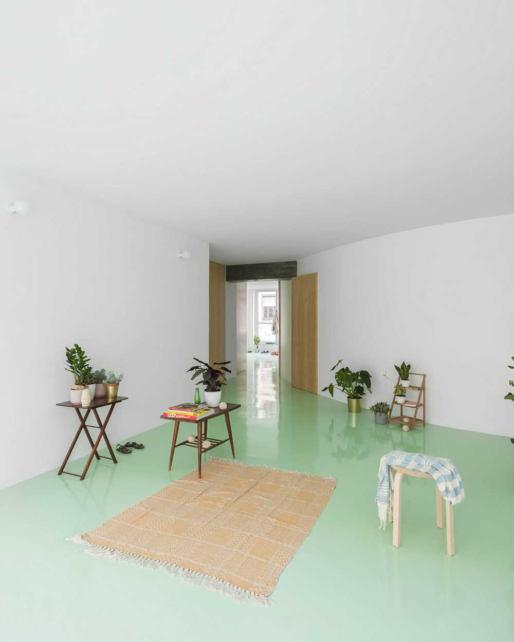 Floor of a redesigned modernist apartment building. The mint green floor links all the spaces